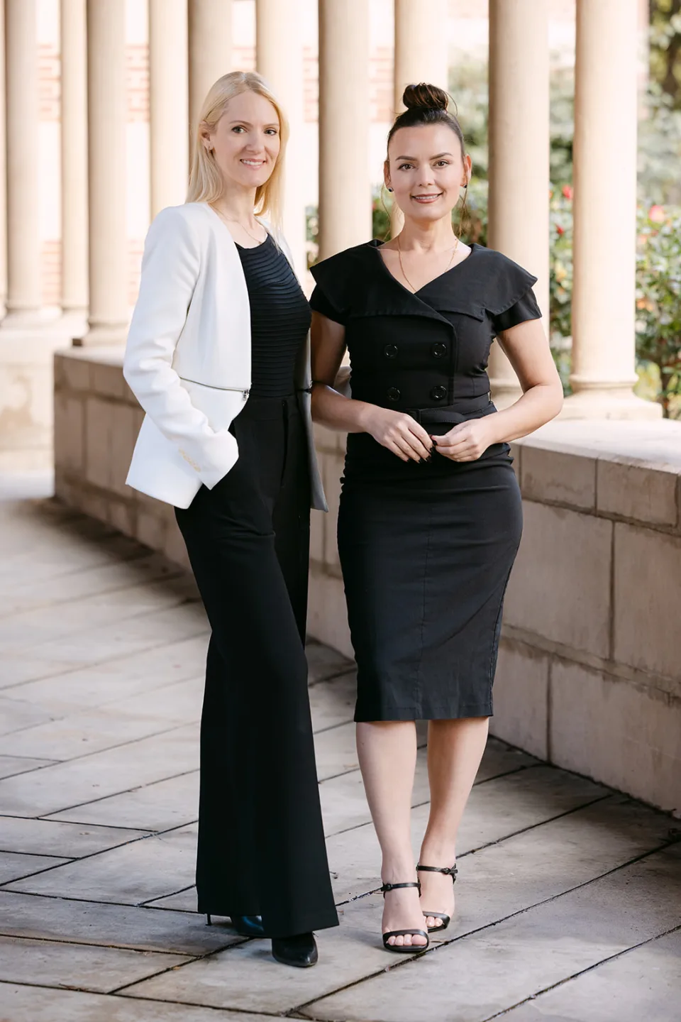US Quest attorneys Ekaterina Kechkina and Elena Oganova standing together outdoors